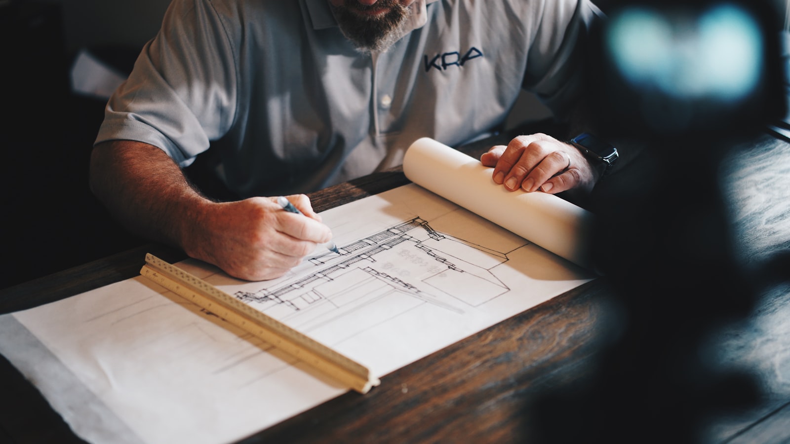 Quantity surveyor reviewing construction drawings and measurements